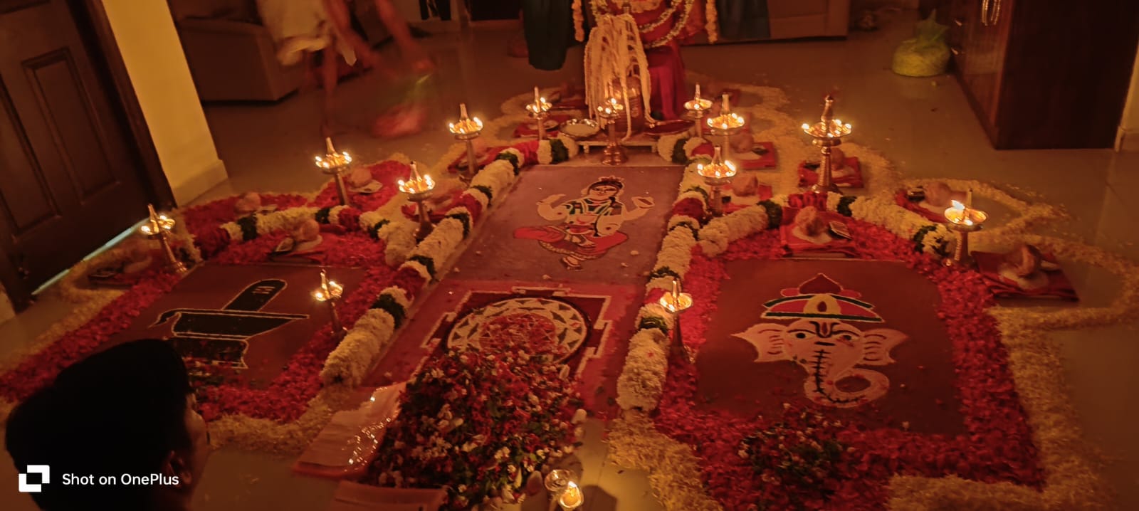 Temple altar with lamps and floral arrangement in Chennai