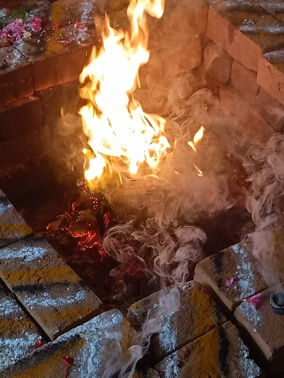 Sacred fire burning in a ritual pit in Chennai